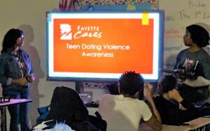 Janisha Lax (left) & Mykaila Dye help students learn about unhealthy relationships