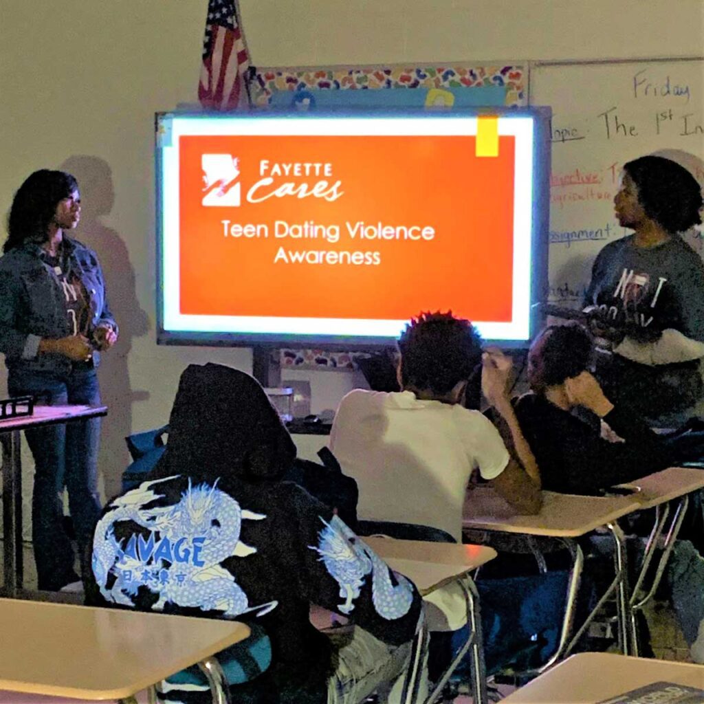 Janisha Lax (left) & Mykaila Dye help students learn about unhealthy relationships